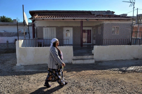 A Roma woman walks next to the house where a 4 year old blonde girl lived in Farsala central Greece 2470236 A Roma woman walks next to the house where a 4 year old blonde girl lived in Farsala central Greece 2470236