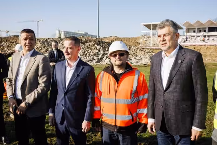 Ciolacu și Grindeanu, în inspecție la marile șantiere din Timișoara a group of men standing in a field